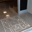 Particolare. Ingresso riservato ai relatori, logo in rilievo.